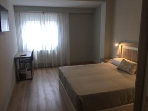 Posteľ alebo postele v izbe v ubytovaní Hotel Celanova