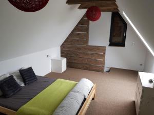 a bedroom with a bed and a stair case at Osada Knurów in Knurów
