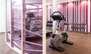 a room with a gym with a exercise bike at AMERON Bonn Hotel Königshof in Bonn