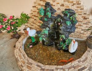 a model of a fish pond in a backyard at Grant Guest House in Adler