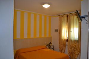 Ένα ή περισσότερα κρεβάτια σε δωμάτιο στο Il Girasole +7 φωτογραφίες