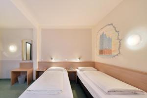 a hospital room with two beds and a mirror at meinHotel in Hamburg