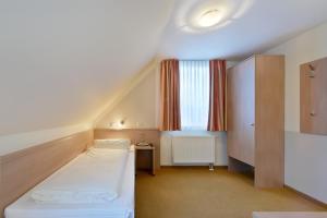 a hotel room with a bed and a window at meinHotel in Hamburg