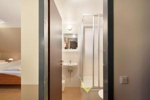 a bathroom with a sink and a toilet and a mirror at meinHotel in Hamburg