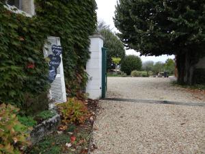 a house with a sign on the side of a driveway at Les Tilleuls - Chambres d'hôtes - La Rochefoucauld in La Rochefoucauld