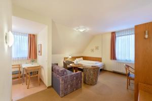 a living room with a couch and a table at meinHotel in Hamburg