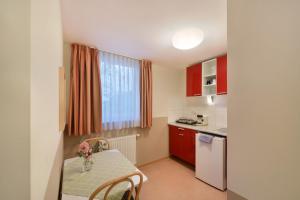 a small kitchen with a table and a table and chairs at meinHotel in Hamburg