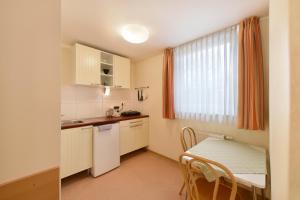 a small kitchen with a small table and a window at meinHotel in Hamburg