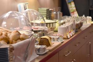 a buffet with bread and pastries on a counter at meinHotel in Hamburg