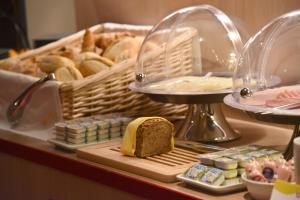 a table with a tray of bread and a basket of pastries at meinHotel in Hamburg