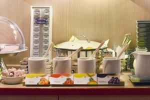 a table with a pot and a tray of food at meinHotel in Hamburg