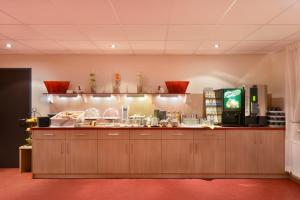 a kitchen with wooden cabinets and a counter at meinHotel in Hamburg