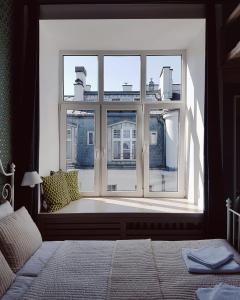 a bedroom with a window looking out at a building at Apartament na Wilczej in Warsaw