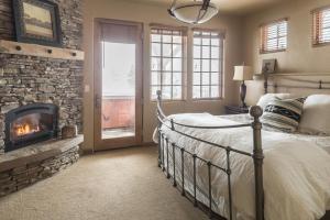 a bedroom with a fireplace and a bed in a room at Big View Luxury Suite in Big Sky Mountain Village