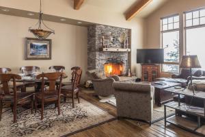 a living room with a table and a fireplace at Big View Luxury Suite in Big Sky Mountain Village