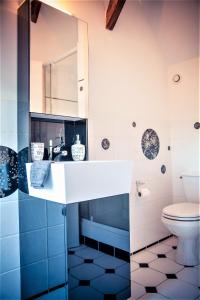 a bathroom with a sink and a toilet at La Chapelle du Chateau Lagarrigue in Strenquels