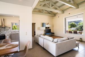 a living room with a couch and a table at Three Stars Luxury Villas in Moraitika