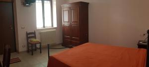 a bedroom with a bed and a dresser and a window at Agriturismo PETRA LUCANA in Montescaglioso
