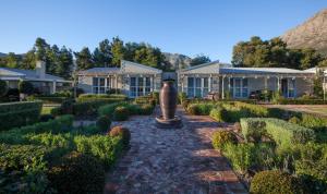 a garden in front of a house at La Cabriere Country House in Franschhoek
