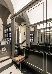 a dressing room with a bench and a mirror at Corso 281 Luxury Suites in Rome
