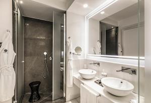 a bathroom with a sink, toilet and bathtub at Corso 281 Luxury Suites in Rome