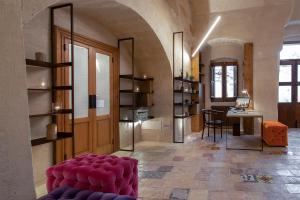 a living room with a red couch and a table at Conche Luxury Retreat in Matera