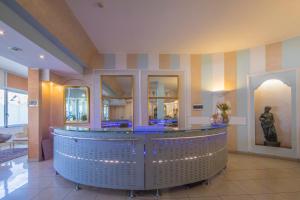 a lobby with a bar with a statue in it at Hotel Ristorante Continental in Osio Sotto