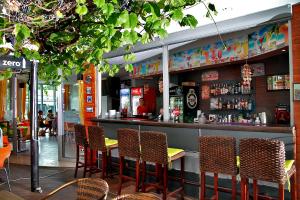 a restaurant with a bar with chairs around it at Favorit Aparthotel in Sunny Beach