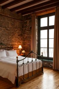 a bedroom with a bed and a brick wall at Auberge du Vieux Port by Gray Collection in Montreal