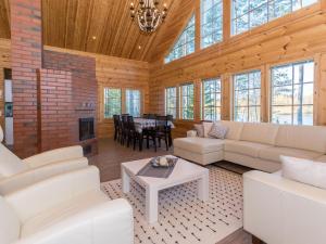 a living room with white furniture and a fireplace at Holiday Home Telkkä by Interhome in Vähäsalmi