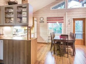 a kitchen and dining room with a table and chairs at Holiday Home Teerenpesä by Interhome in Tahkovuori