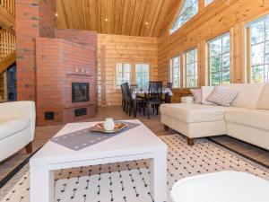 a living room with white furniture and a fireplace at Holiday Home Telkkä by Interhome in Vähäsalmi