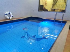a swimming pool with a person in the water at Al Worod Al Thahabia Chalets in Abha