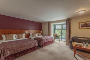 a hotel room with two beds and a window at Silverbirch Hotel in Omagh
