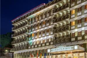 a facade of a hotel at night at Grand Hotel Fleming by OMNIA hotels in Rome