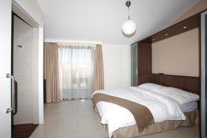 Postel nebo postele na pokoji v ubytování Motel Le Léman