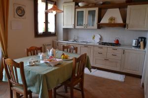 a kitchen with a table with a bowl of fruit on it at Podere Casalsole in Certaldo