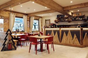 a restaurant with wooden walls and tables and chairs at Alpen Chalet in Schilpario