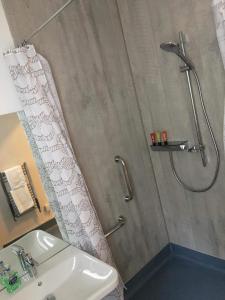 
a bathroom with a shower and a sink at Lunan House Hotel in Arbroath
