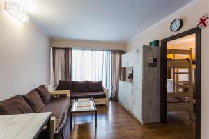 a living room with a couch and a bunk bed at APT 7 Mgzavrebi in Bakuriani