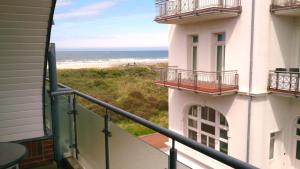 a view of the beach from the balcony of a building at Strandhotel Juister Hof in Juist