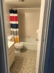 a bathroom with a toilet and a shower curtain at Sea Palm G in Fort Walton Beach