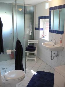 a bathroom with a shower and a toilet and a sink at Wasserturm Cuxhaven in Cuxhaven