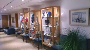 a room with wooden shelves and a table with chairs at Strandhotel Juister Hof in Juist