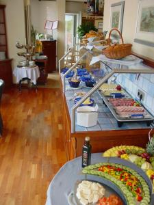 a buffet with many different types of food on display at Strandhotel Juister Hof in Juist