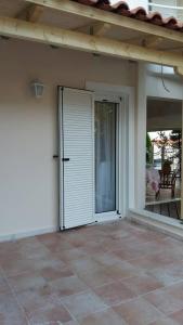 an open door of a house with a patio at NN Luxury Room near Athens Airport in Spáta