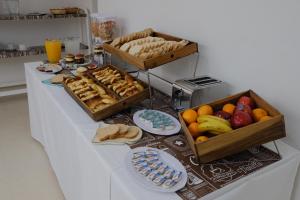 a table with two baskets of bread and fruit at Bagu Playa Grande Hotel in Mar del Plata