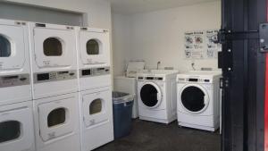 a laundry room with white washers and washing machines at InTown Suites Extended Stay Houston TX - Jersey Village in Houston