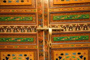 a wooden door with intricate designs on it at Riad Khouloud in Fez