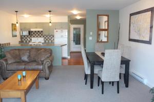a living room with a couch and a table at Siennas Harbour House in Tofino
